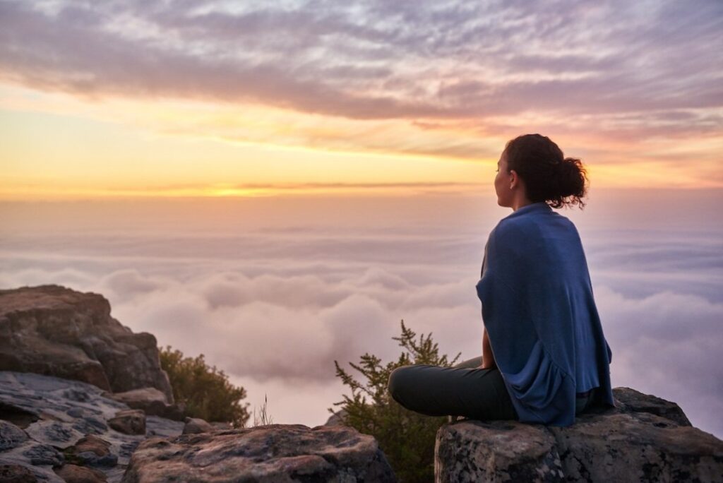 Person practicing meditation in a serene environment with a calm expression, symbolizing effective stress management