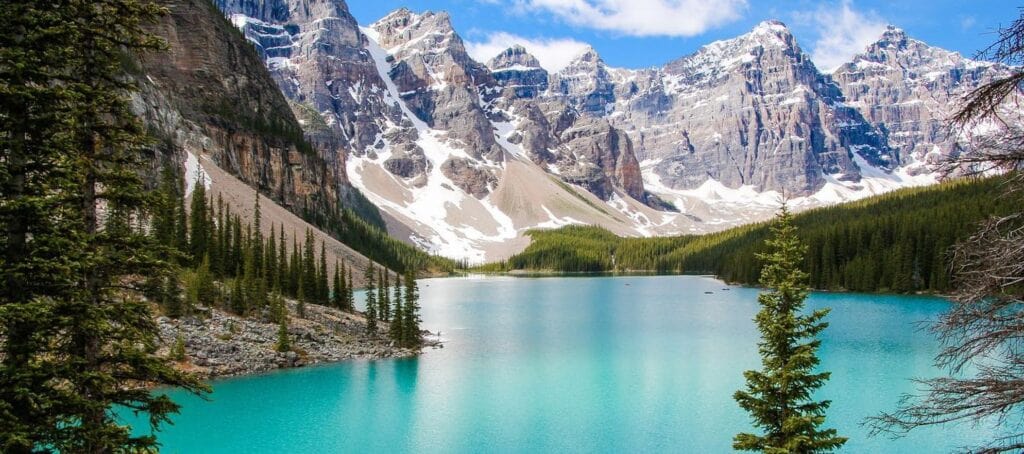 Scenic view of Banff National Park with turquoise lakes, snow-capped mountains, and lush forests in Canada