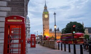 Big Ben with a red telephone box and a red bus in London.